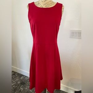 Sleeveless red dress perfect for work or a holiday party.